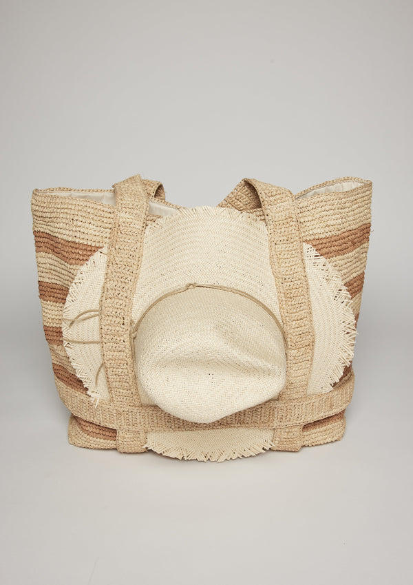 Tan stripe beach tote with fringe brimmed sun hat attached with straps