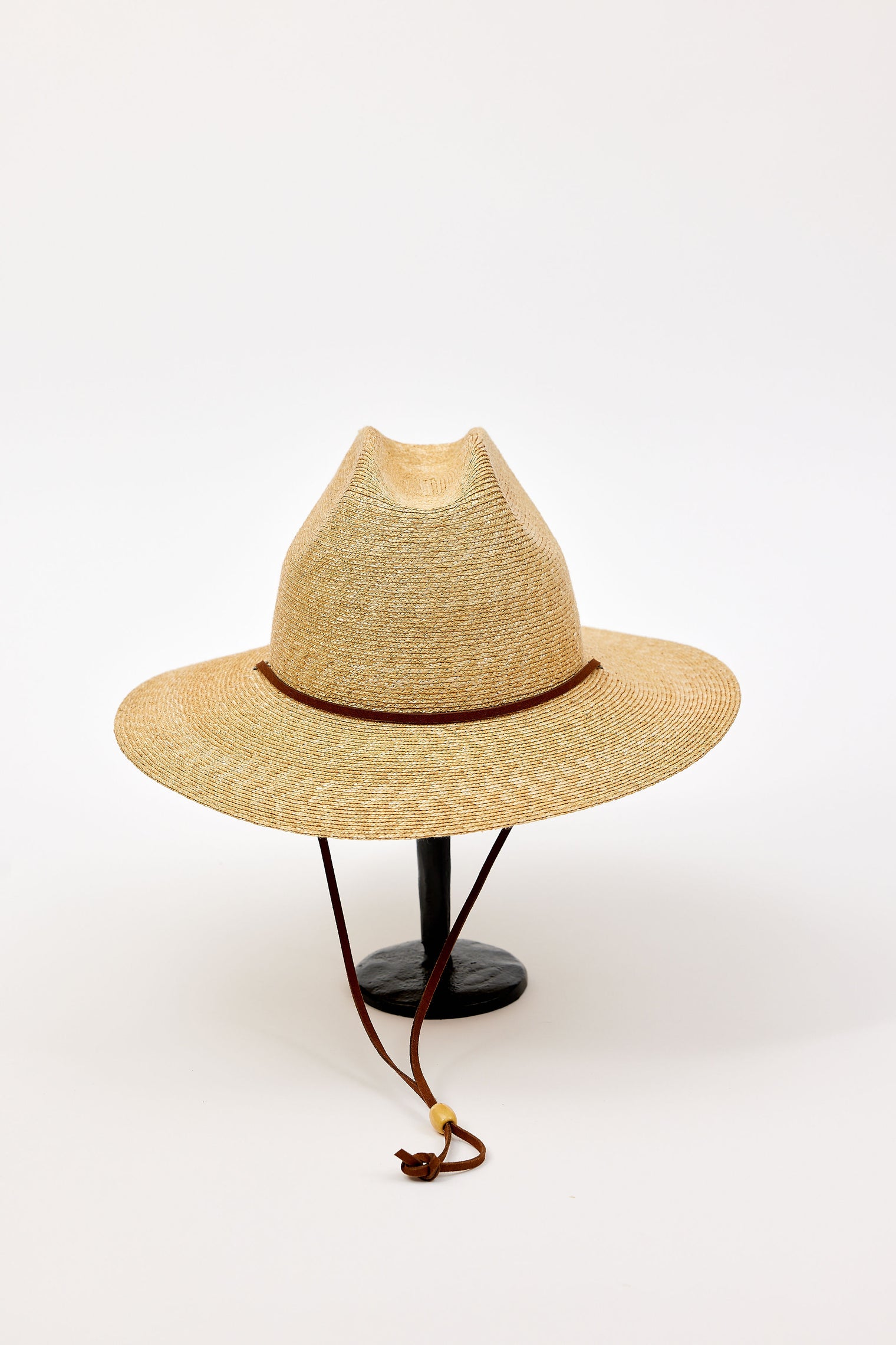 Straw hat with a brown band on a white background