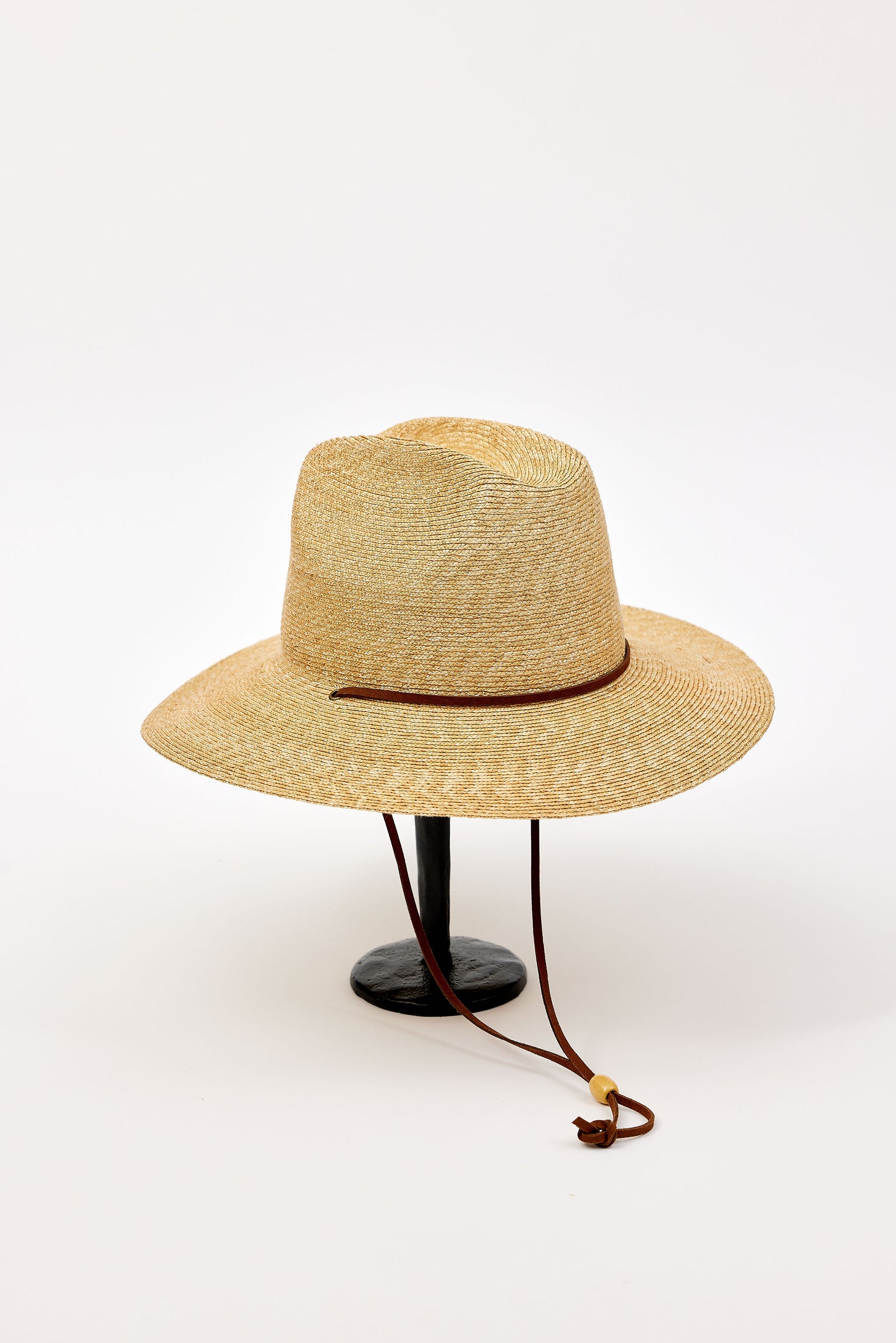 Straw hat with a brown band on a white background