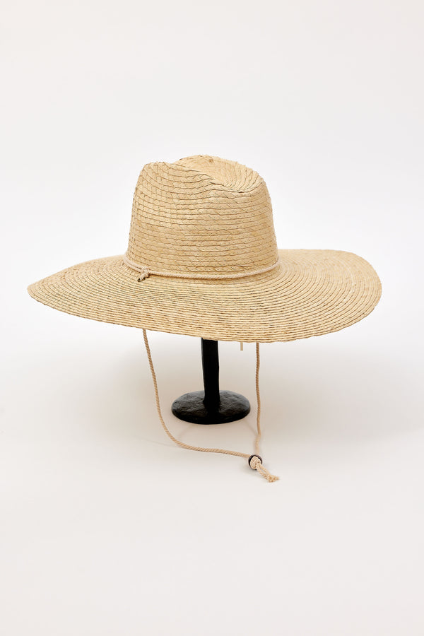 Beige straw hat with a chinstrap on a white background