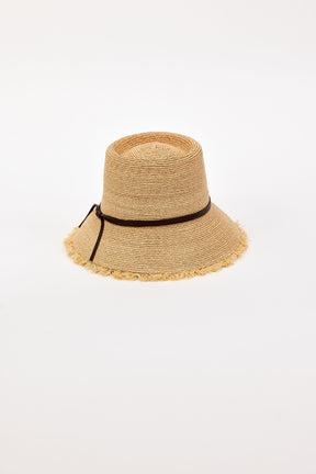 Beige straw bucket hat with a black band on a white background