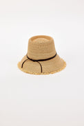 Beige straw bucket hat with a black band on a light beige background