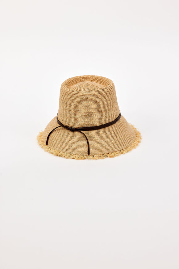 Beige straw bucket hat with a black band on a light beige background
