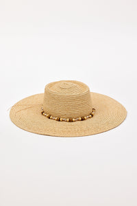 Beige straw hat with a wide brim and beaded trim detail on a white background