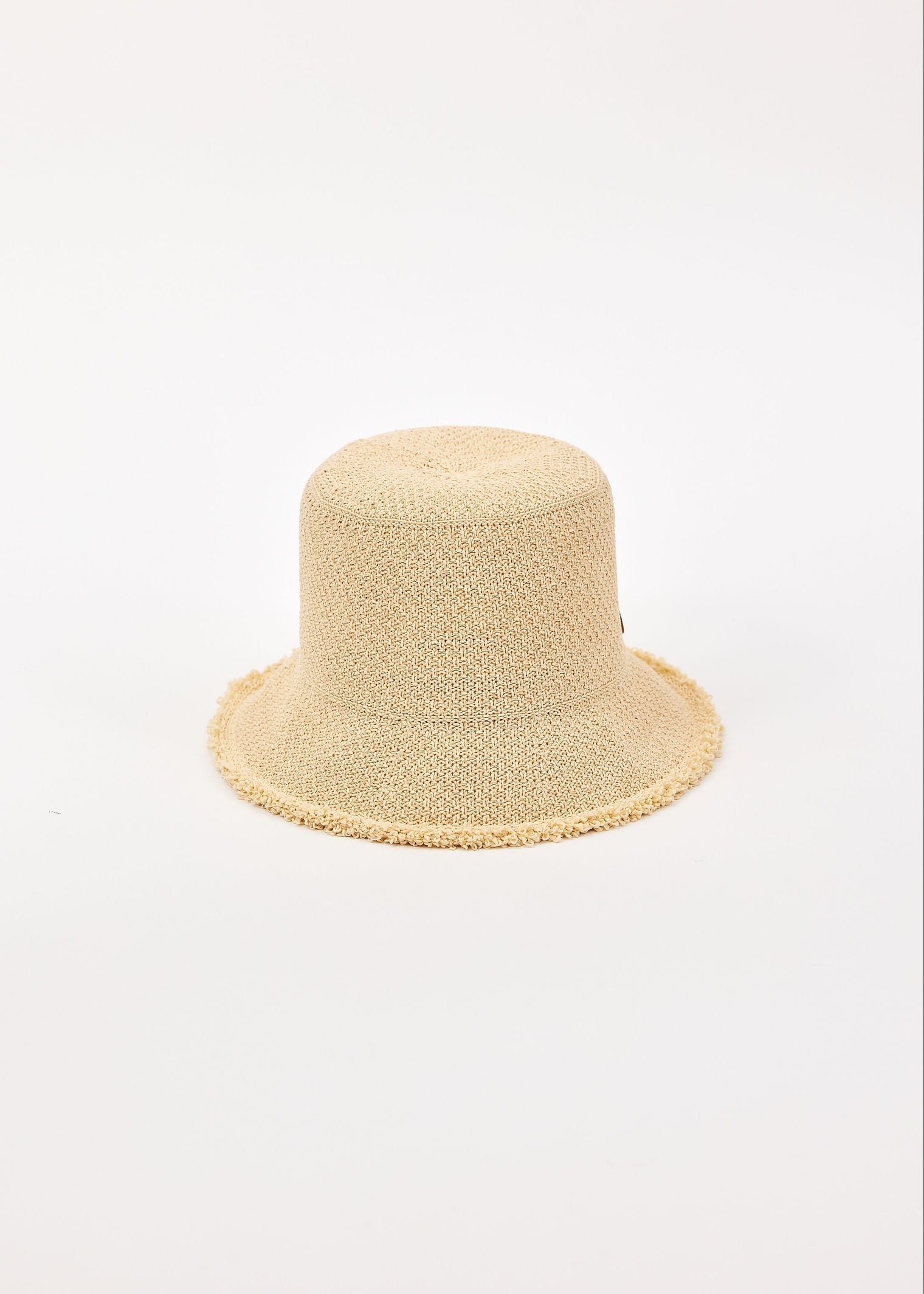 Beige woven bucket hat on a light beige background