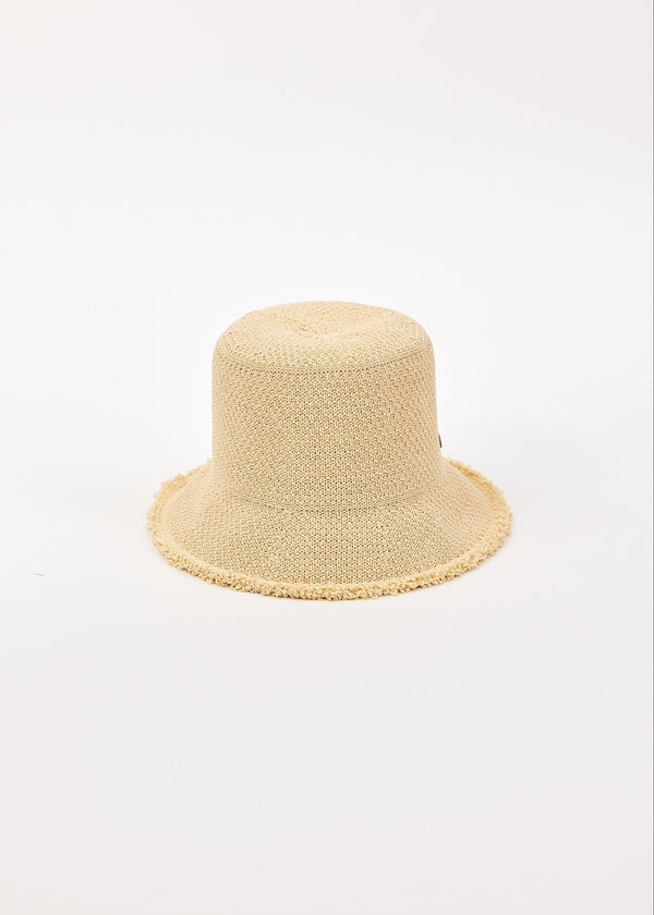 Beige woven bucket hat on a light beige background
