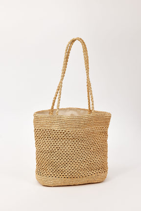 Woven straw bag on a white background