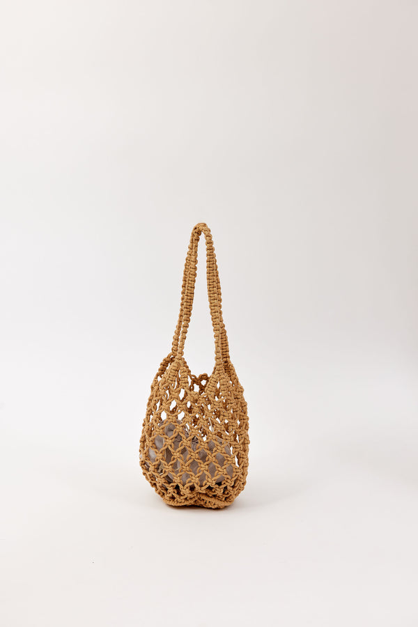 Brown open weave handbag on a white background