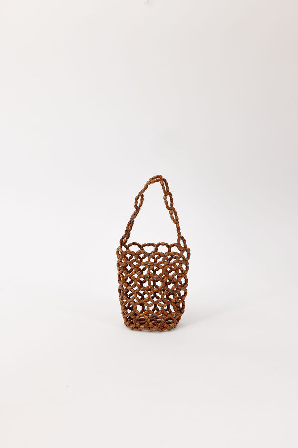 Brown beaded handbag on a white background