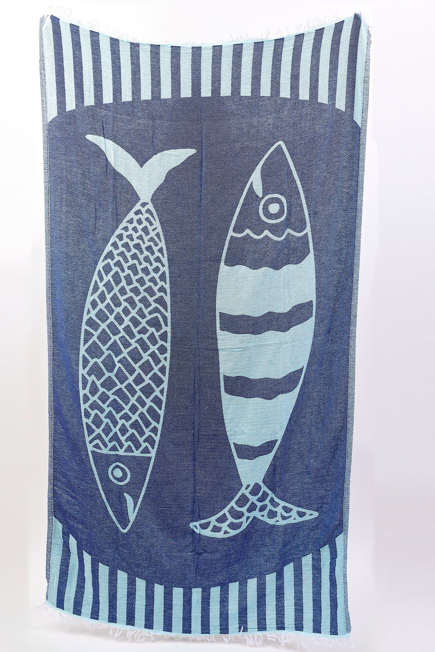 Towel with fish design and striped border on a white background