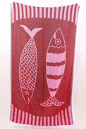 Red towel with white fish design and striped border on a white background