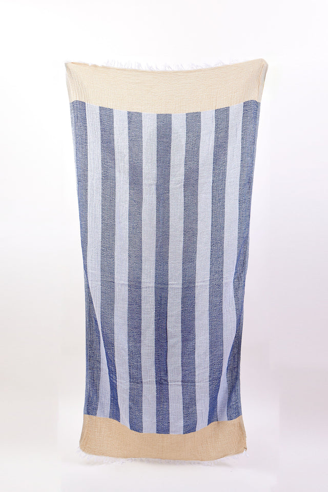 Striped towel with blue and white pattern on a beige background