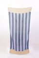 Striped towel with blue and white pattern on a beige background
