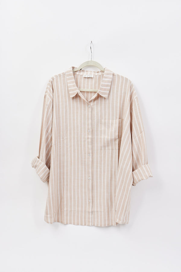 Striped shirt on a hanger against a white background