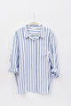 Blue and white striped shirt on a hanger against a white background