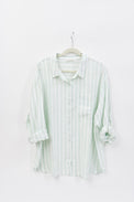 Striped shirt on a hanger against a white background