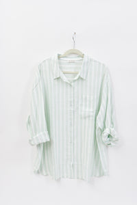 Striped shirt on a hanger against a white background