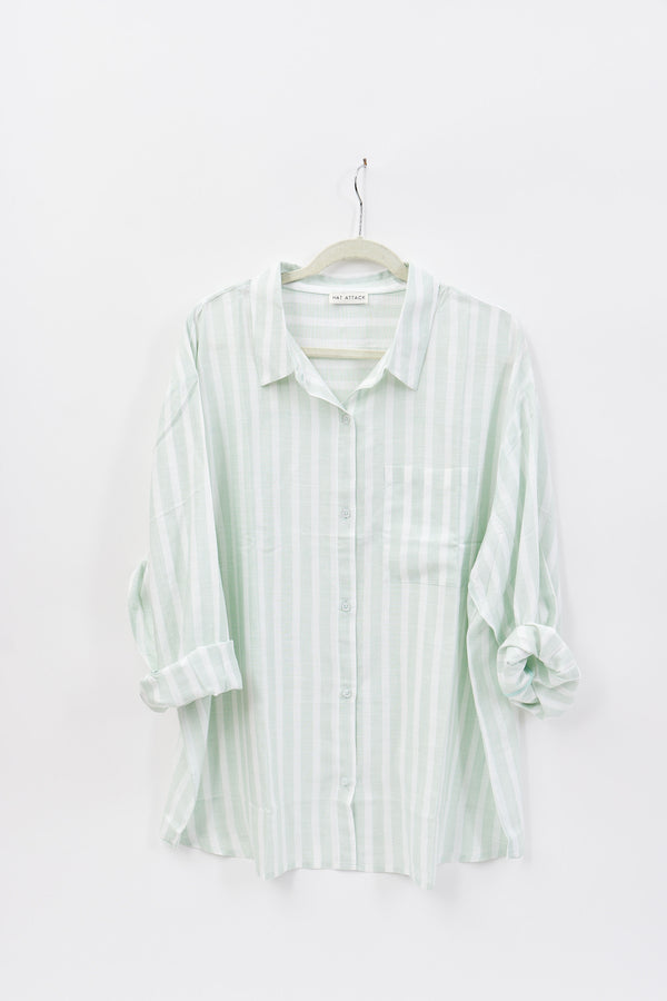 Striped shirt on a hanger against a white background