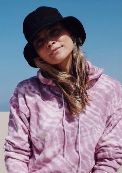 Model wearing black cotton bucket hat at the beach