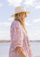 Classic Packable Travel Hat with Fringe in Bleach on beach