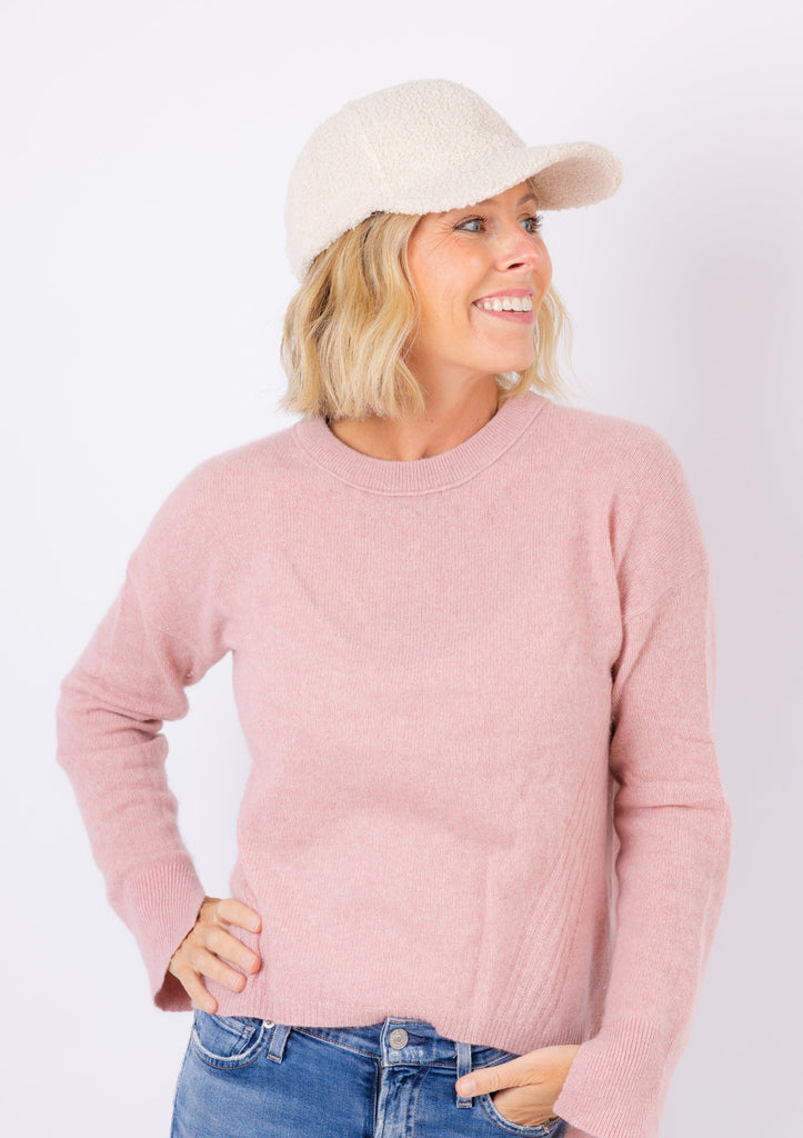Sherpa Cap in parchment on model in pink sweater with hand in pocket