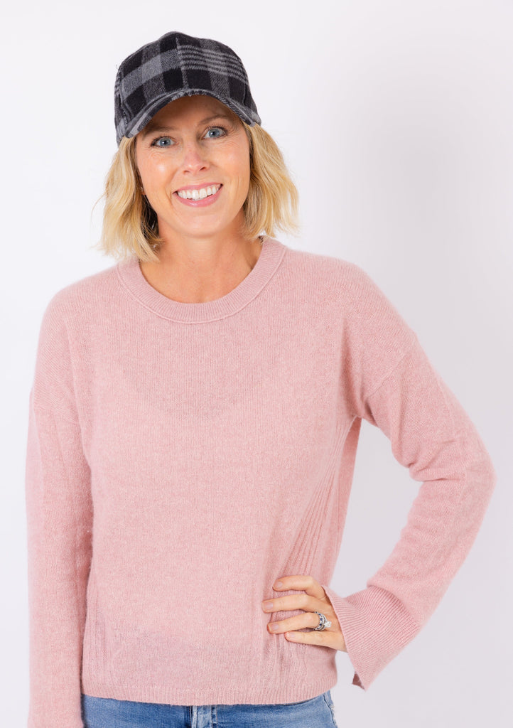 Black and Grey plaid baseball hat on model wearing pink sweater