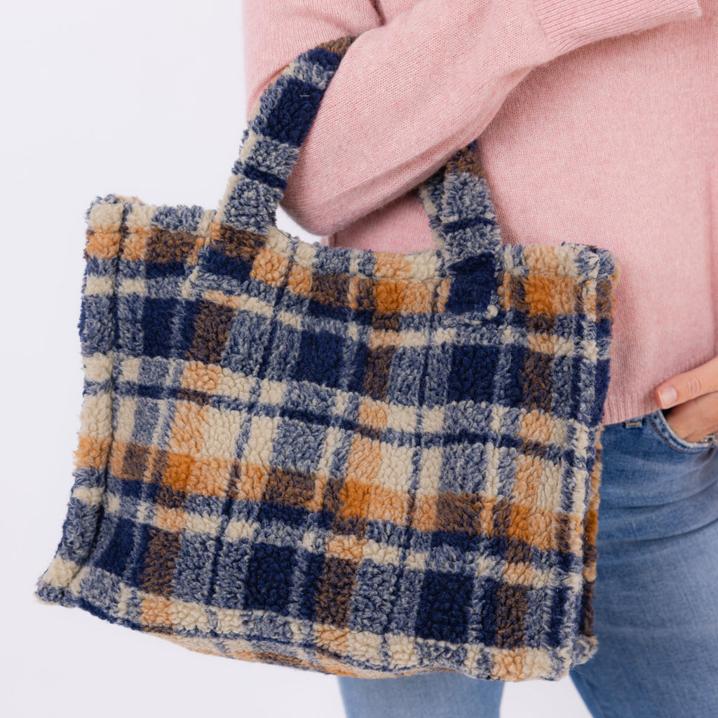 Model holding small teddy tote