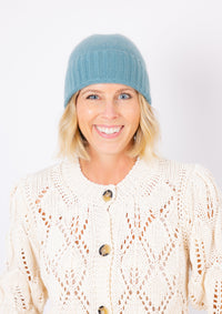 Cashmere Slouchy Cuff beanie in marine blue on model in ivory sweater