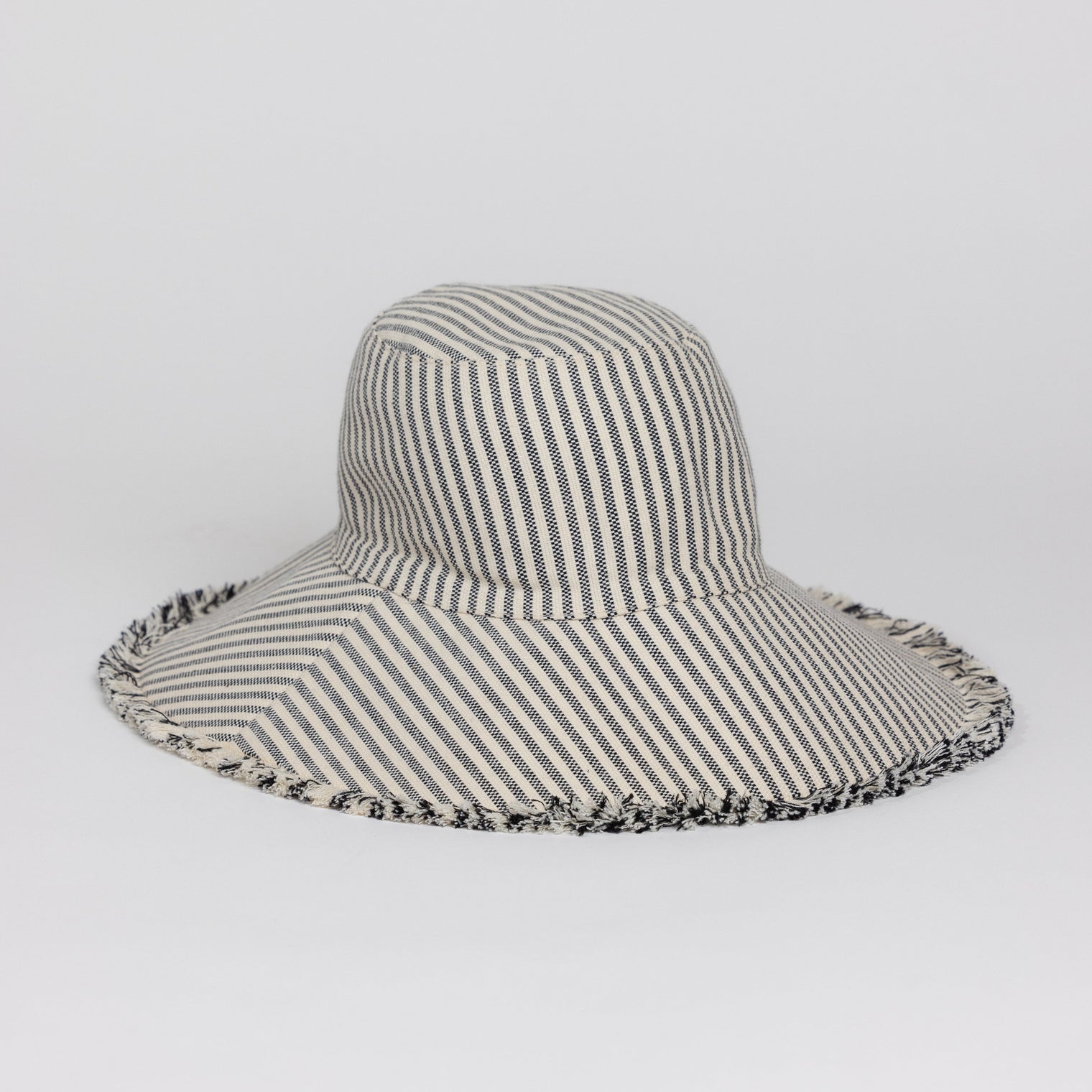 3/4 angle of Canvas Packable Bucket Hat in Black Stripe
