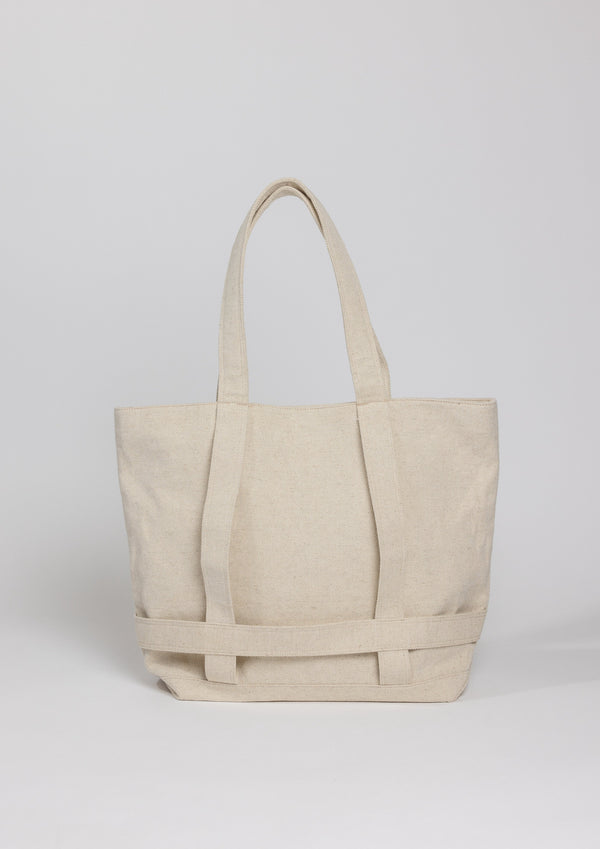 Natural colored canvas bag with straps to hold a hat