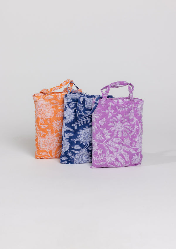 Lavender, coral and blue floral sarongs in mini bags