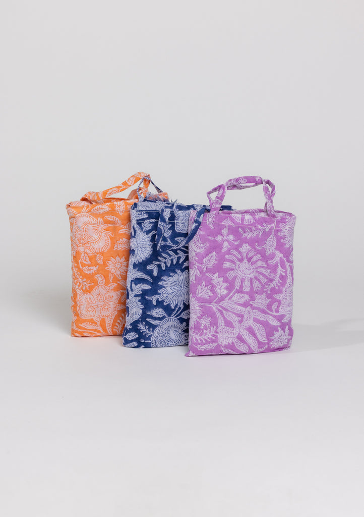 Coral, blue and lavender floral sarongs in bags
