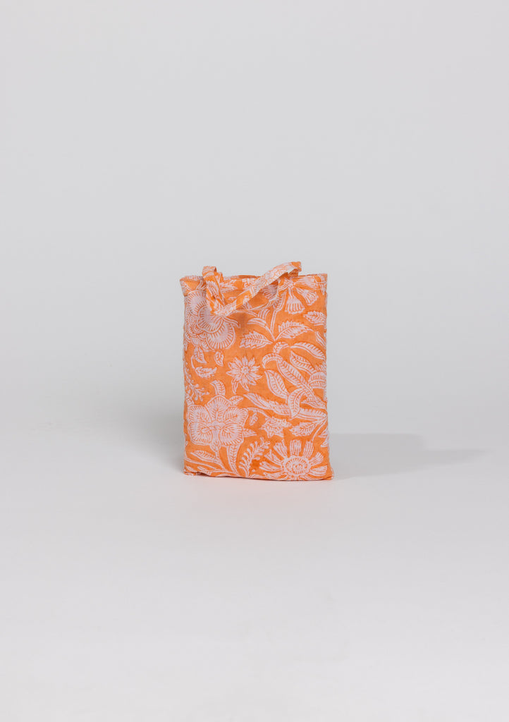 Coral floral sarong in bag
